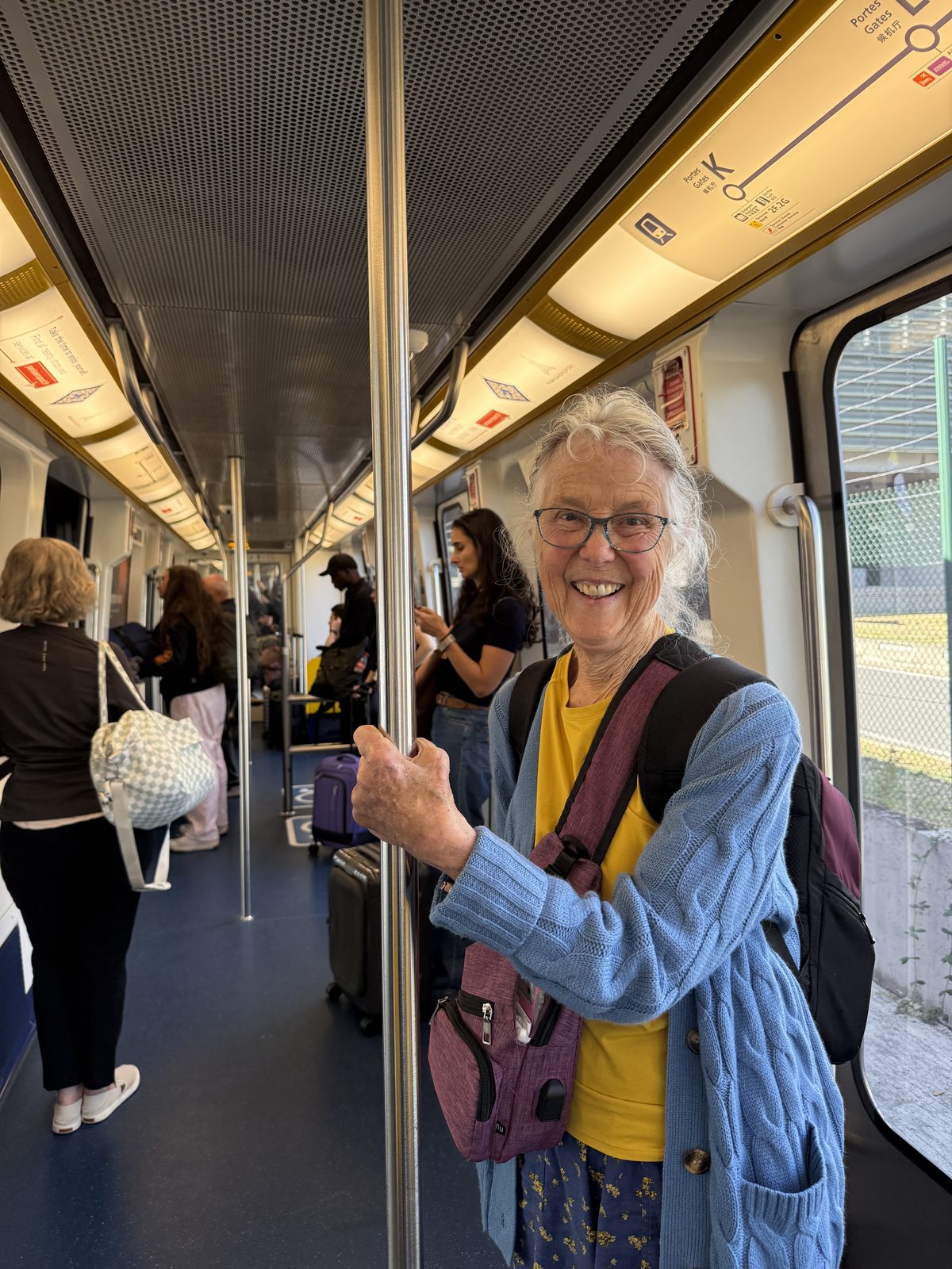 Liz on the CDG airport train, backpacks on and ready for the next leg.