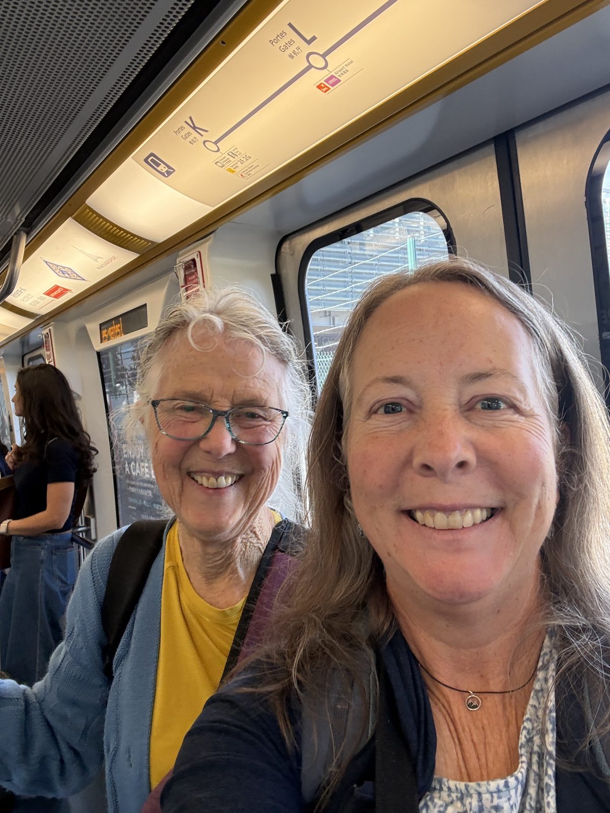 Liz and a travel companion on the CDG airport train.