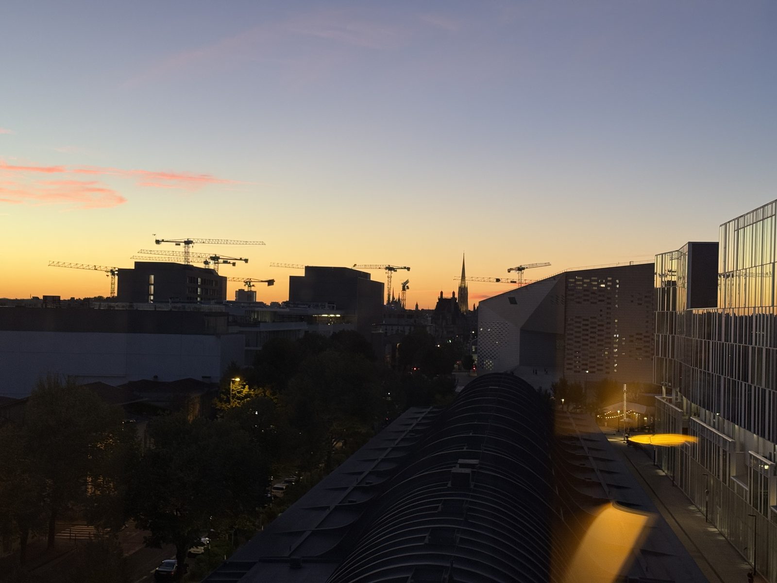 Another view of the Bordeaux sunset, church spire in the distance.
