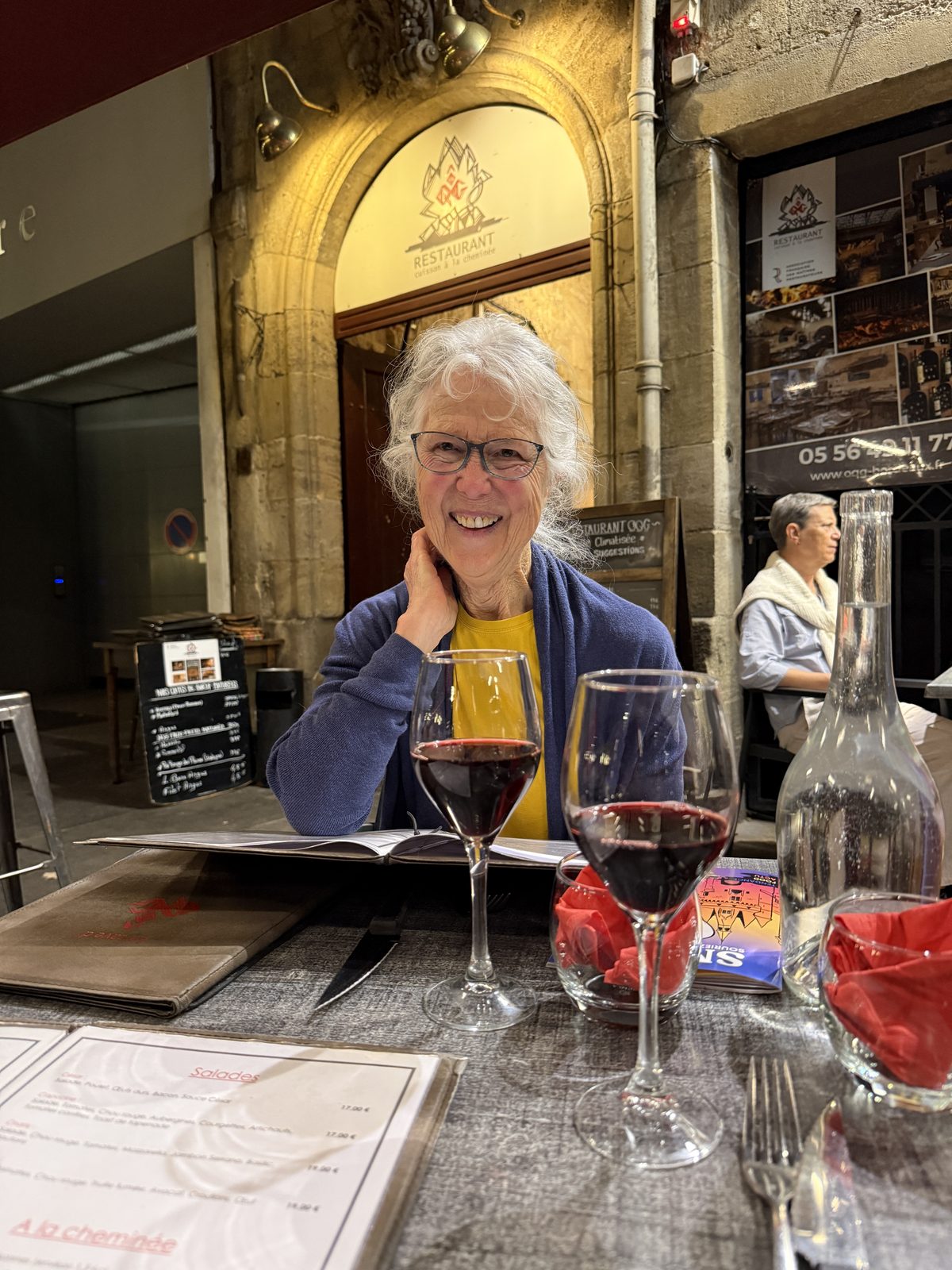 Liz with a glass of red wine outside Restaurant OGG in Bordeaux.