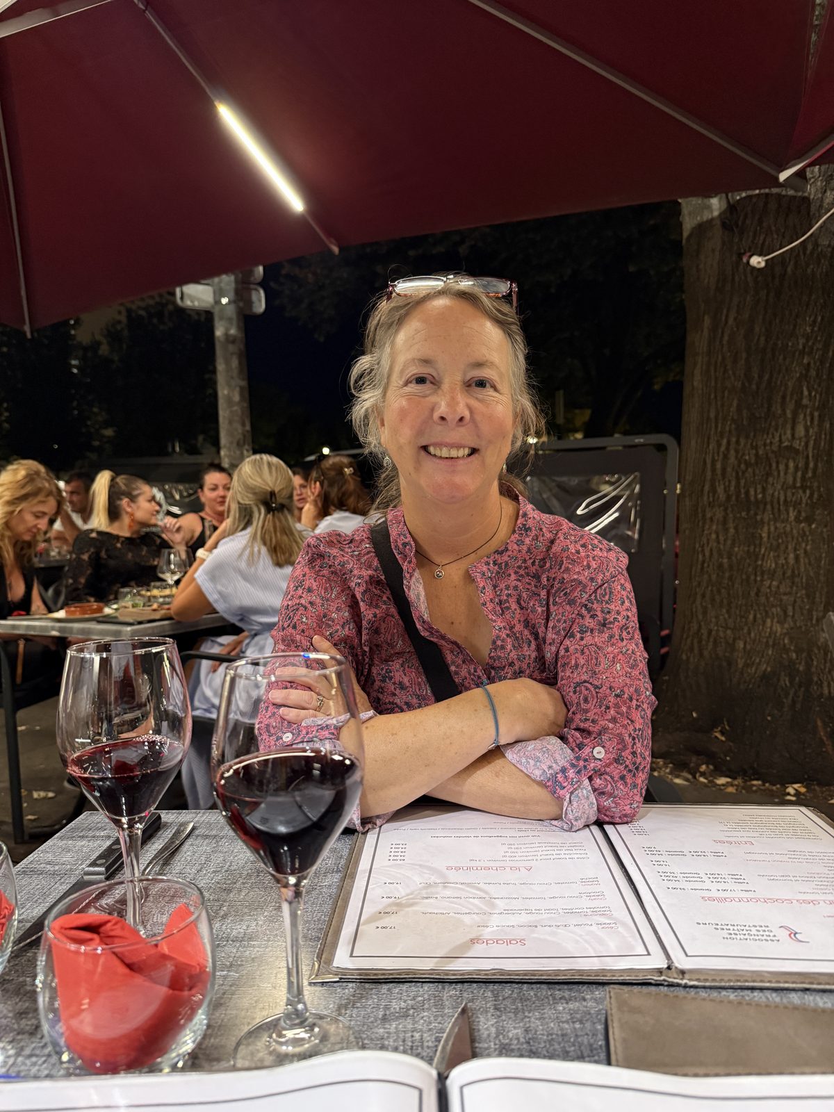 Dinner outside on a Bordeaux terrace, wine glasses on the table.