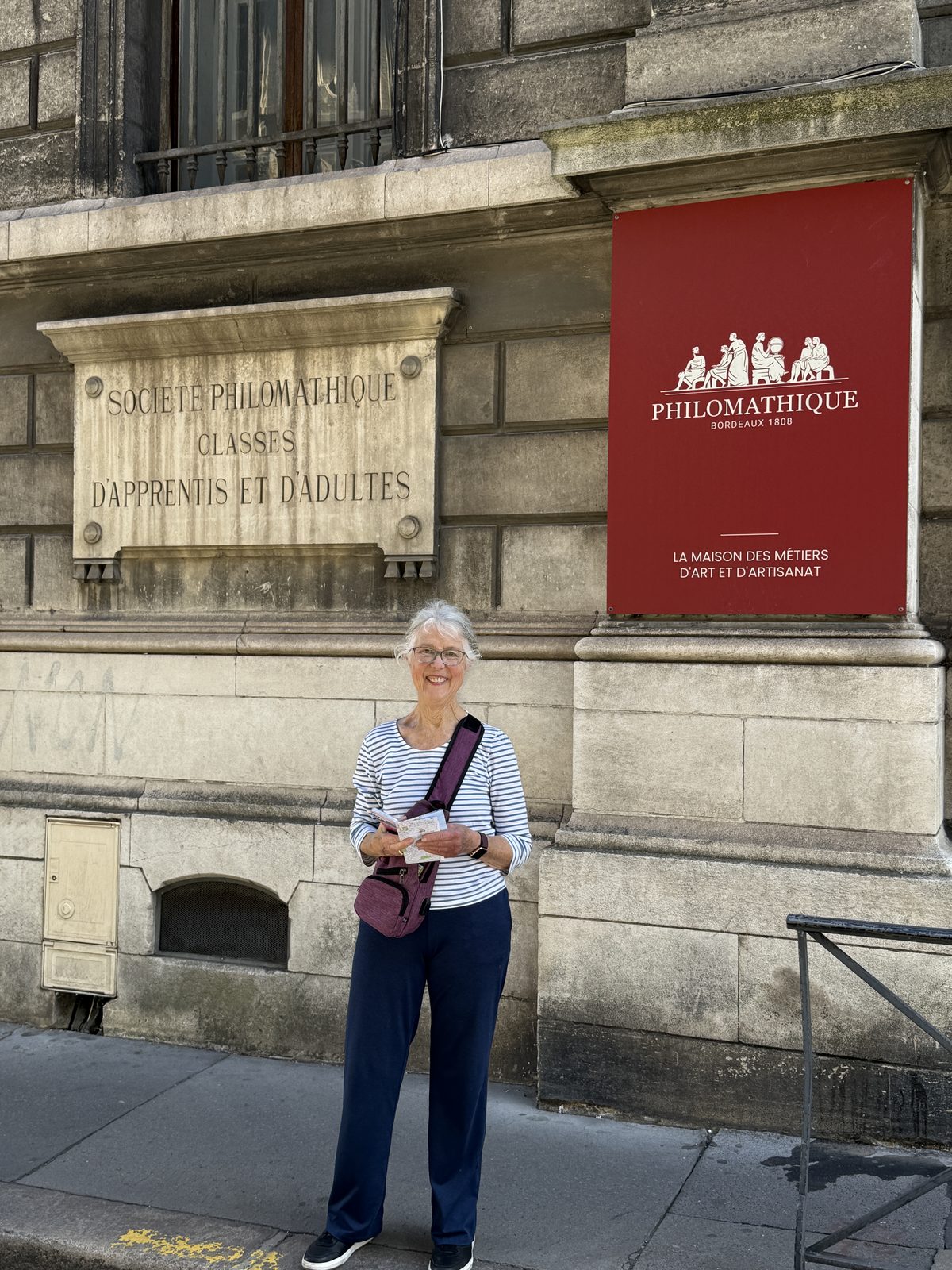 Beth outside the Société Philomathique, an 1808 society "la maison des métiers d'art et d'artisanat."