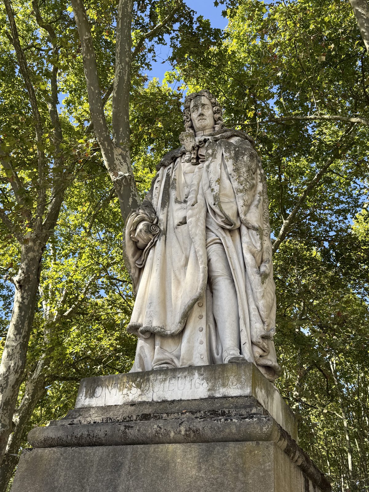 The marble statue of Montesquieu at the Quinconces esplanade.