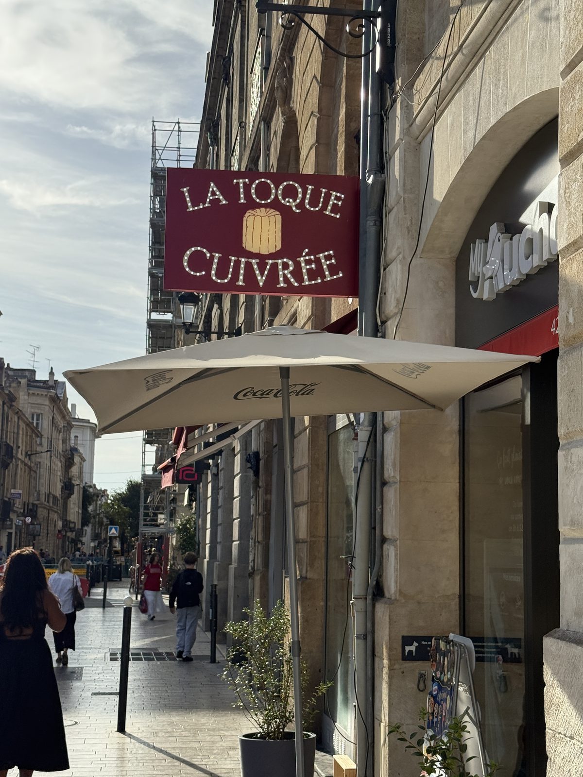 La Toque Cuivrée, a shop sign catching the late-afternoon sun.